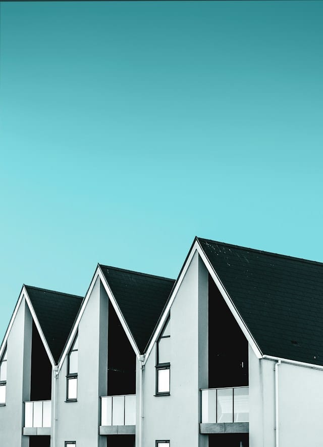 Light coloured exterior houses with dark roofing